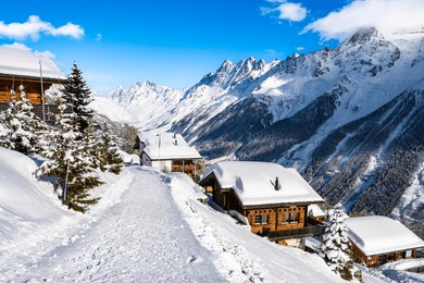 winter snowy road with typical wooden houses in alpine village, loetschental valley, switzerland
