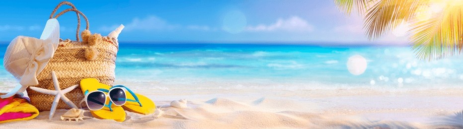 summer vacation - accessories in bag in tropical beach with defocused ocean