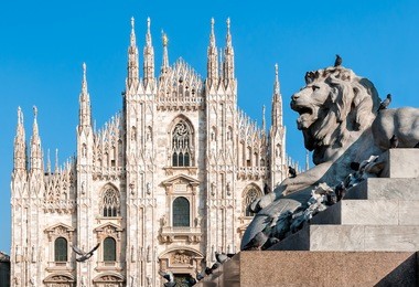 milan cathedral with monument of lion, italy