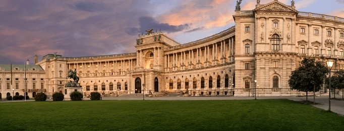 vienna, austria, august 17, 2022. magnificent view of the hofburg imperial palace at sunset, the warm evening light enhances the imposing facade. large format shot.