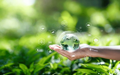green technology or environmental technology to sustainable development goal (sdgs) concept. hands holding global with environment icon on a green background. business value chain. net zero concept.