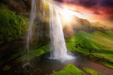beautiful and dramatic sunset in seljalandsfoss waterfalls, iceland
