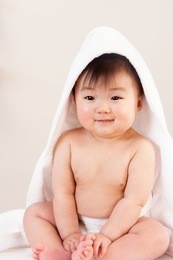 happy baby wrapped in towel