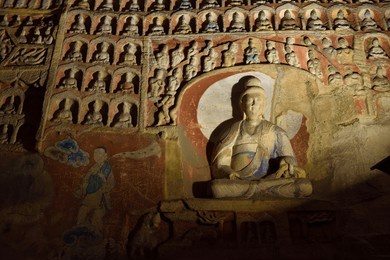the buddha statue at yungang grottoes, its an ancient buddhist temple grottoes near the city of datong in the chinese province of shanxi.