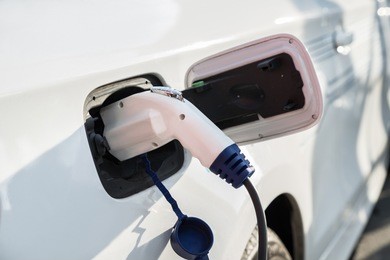 charging an electric car with the power cable supply plugged in