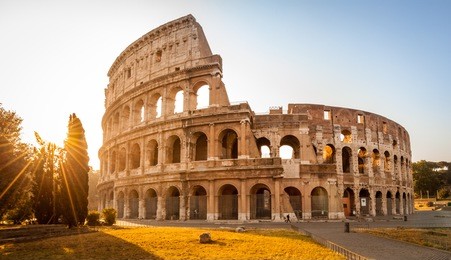 colosseum at sunrise in rome, italy, europe. rome ancient arena of gladiator fights. rome colosseum is the best known landmark of rome and italy