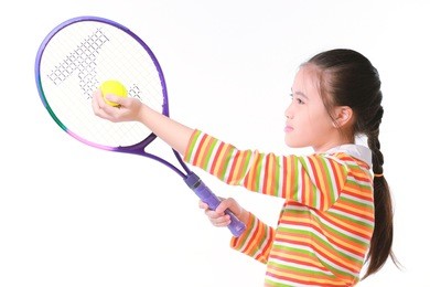 little girl playing tennis on white background