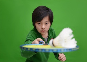 asian boy in badminton action 