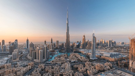 dubai downtown day to night transition timelapse with burj khalifa and other towers view from the top before new year celebration in dubai, united arab emirates. lights turning on.