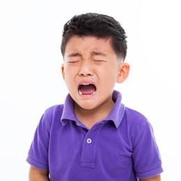 crying asian boy isolated on white