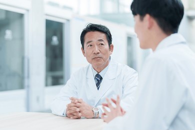 asian scientists discussing in a laboratory