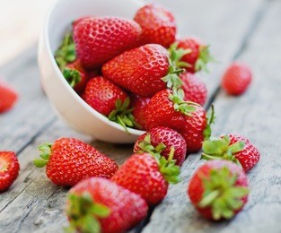 ripe red strawberries on wooden table