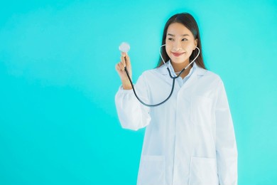 portrait beautiful young asian doctor woman with stethoscope for use in clinic or hospital on blue isolated background