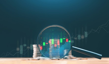 stack of money coin and magnifying glass with graph and candle stick chart. business and financial concept. stock market analyzing, stock information search.
