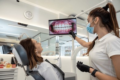 beautiful patient came to the dentistry and consults with a female doctor. dentistry consultation on further treatment