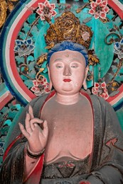 ancient buddha statue in zhenguo temple, a large buddhist temple in the shanxi province of china. founded in the year 963, parts of unesco world heritage site. 