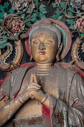 ancient buddha statue in zhenguo temple, a large buddhist temple in the shanxi province of china. founded in the year 963, parts of unesco world heritage site. 