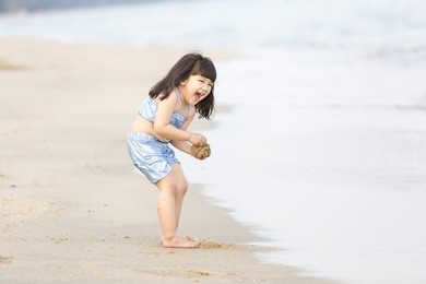 asian kid girl on the beach