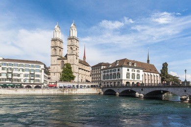 view of grossmunster church in zurich old town, on the river side of limmat, zurich, switzerland