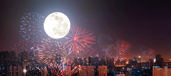 mid-autumn festival concept: fireworks celebration with super moon in the city