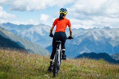 woman riding mountain bike in the beautiful mountains