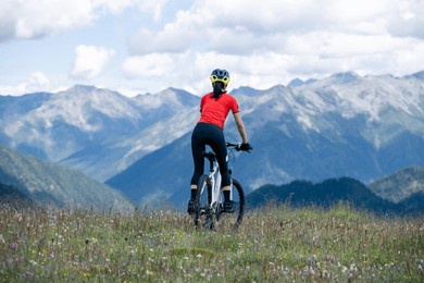 woman riding mountain bike in the beautiful mountains