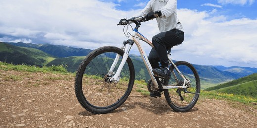 riding mountain bike on grassland mountain top