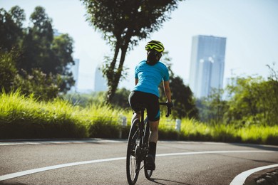 woman cycling on summer park trail