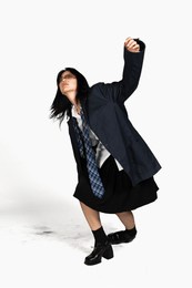 young asian female office worker, full body fashion photoshoot in studio, isolated on white background, the concept of office syndrome, crazy pose.