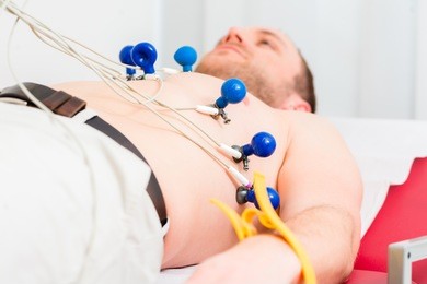 male patient having ecg electrocardiogram in hospital