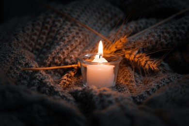 scented candle burn in glass jar. comfort at home. candle in a glass jar. scent and light. scented handmade candle. aroma therapy. christmas and winter mood. cozy home decor. festive decoration.