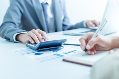 business people discussing the charts and graphs showing the results of their successful teamwork