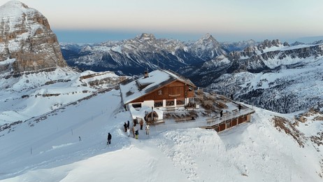 dolomity winter scenery with snow and rifugio.