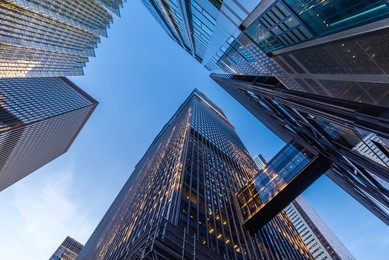 office buildings stretch up to the blue sky in the financial district in downtown toronto ontario canada.
