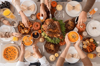 happy family having dinner at festive table on thanksgiving day, top view