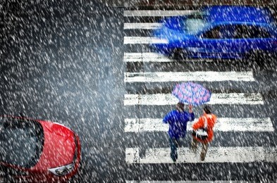 pedestrian crossing with car in the heavy snowfall