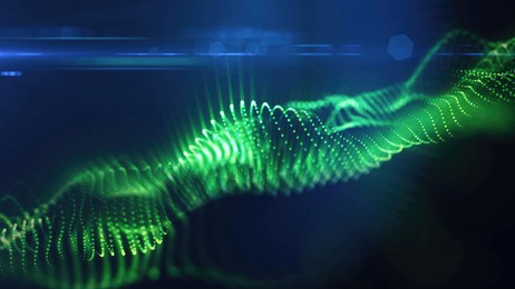 a green, glowing particle wave forms a dynamic curve, suggesting energy, sound, or data visualization on a dark background.