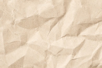 close-up view of a crumpled brown paper texture, ideal for various design projects, backgrounds, or crafts needing an organic and textured feel.