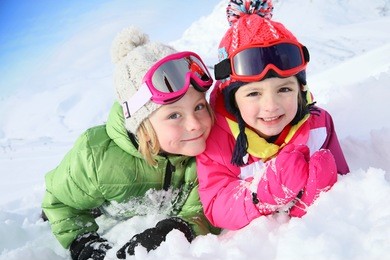 portrait of kids enjoying winter vacation at ski resort