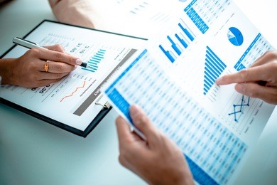 business people discussing the charts and graphs showing the results of their successful teamwork