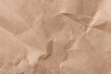 brown background with a crumpled paper texture. the background features a natural, earthy brown color with a rustic, textured look. light brown background. craft paper texture background.