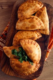 fried chebureks, deep-fried, mini, on a chopping board, wooden table, close-up, no people,