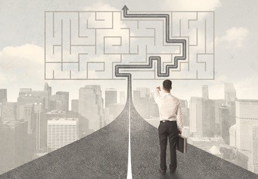 businessman looking at road with maze and solution concept