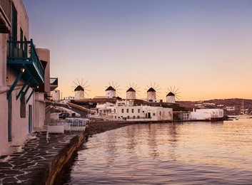 windmills in mykonos, early morning sunrise.