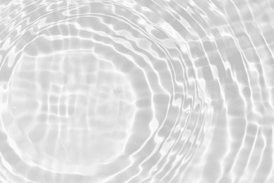 white water with ripples on the surface. defocus blurred transparent white colored clear calm water surface texture with splashes and bubbles. water waves with shining pattern texture background.
