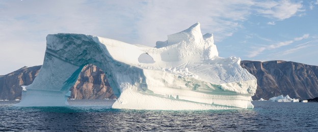 big icebergs in atlantic ocean, icefjord in western greenland. blue sea and the blue sky at sunrise
melting icebergs by the coast of greenland. ecology, climate change global warming. aerial view