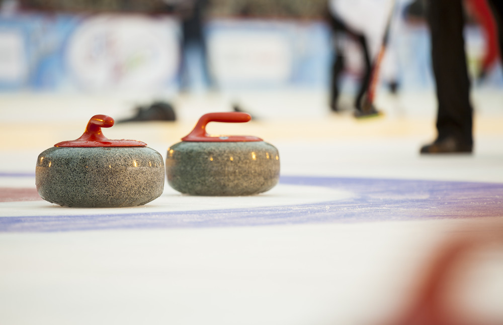 curling stones on ice