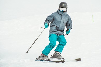 young man learning to ski on a snowy slope close up front view isolated pose