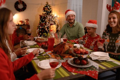 happy multi-generational families gather at home for christmas, exchange christmas gifts and enjoy spending time together during the winter holidays.