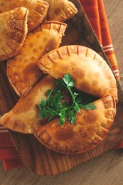 fried chebureks, deep-fried, mini, on a chopping board, wooden table, close-up, no people,